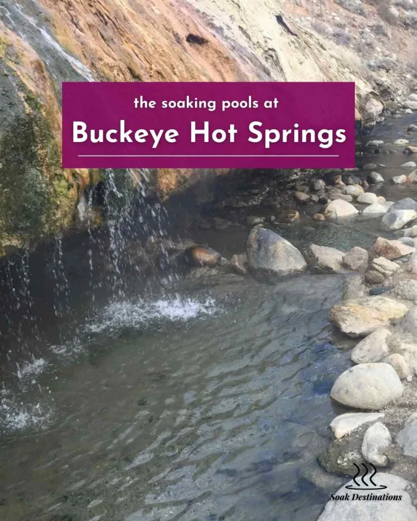Thermal water cascades down colorful mineral cliffs into the soaking pools at Buckeye Hot Springs.