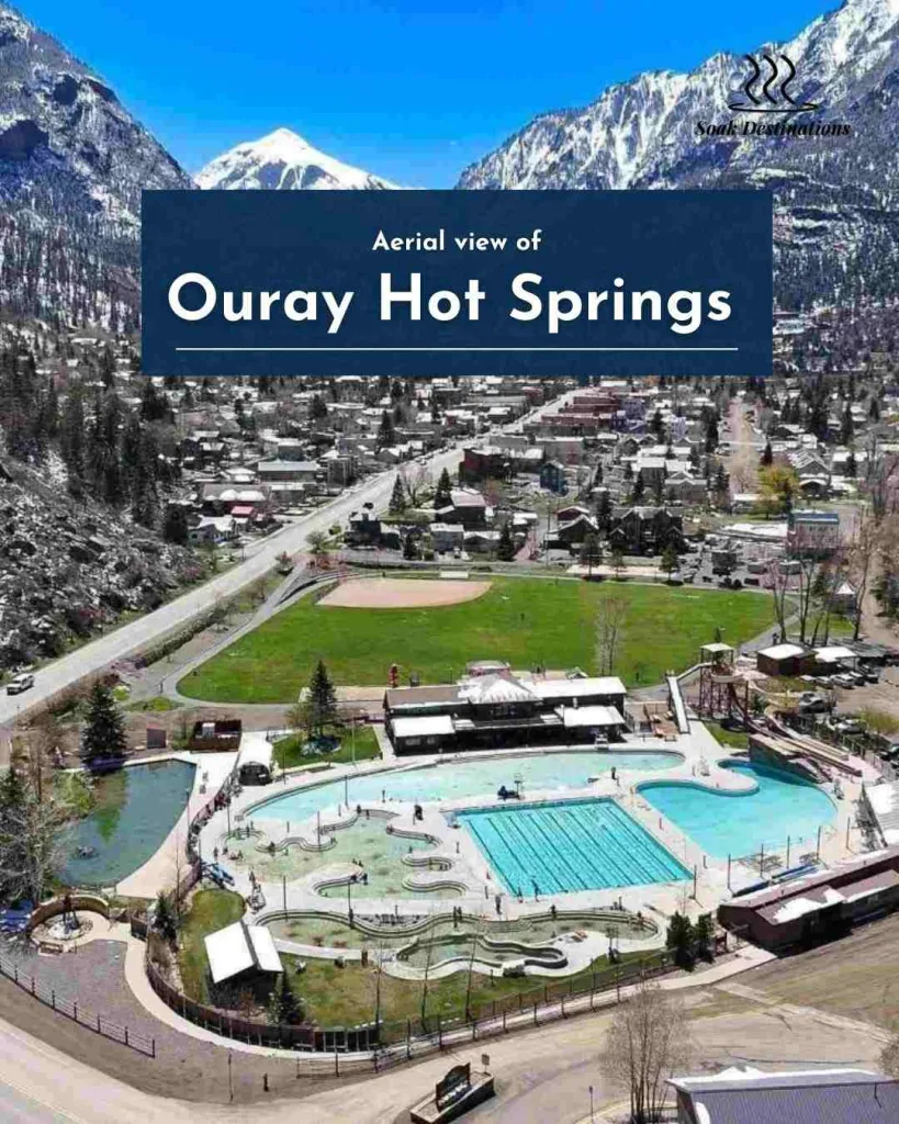 Aerial view of Ouray Hot Springs facility nestled within a valley of snowy Colorado mountain peaks.