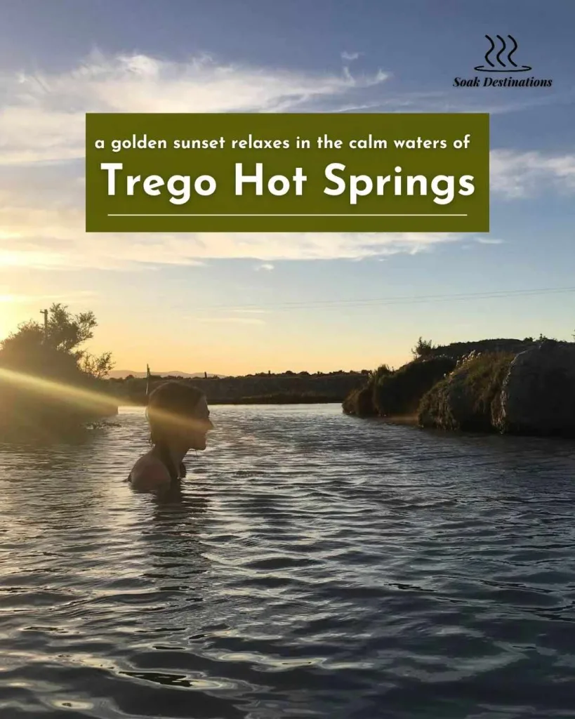 A person silhouetted against a golden sunset relaxes in the calm waters of Trego Hot Springs.