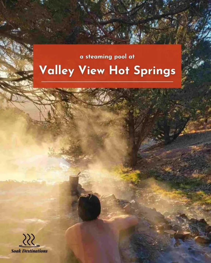 A man relaxes in a steaming pool at Valley View Hot Springs during a golden sunset.