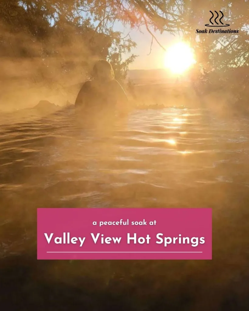 A person silhouetted against the setting sun enjoys a peaceful soak at Valley View Hot Springs.