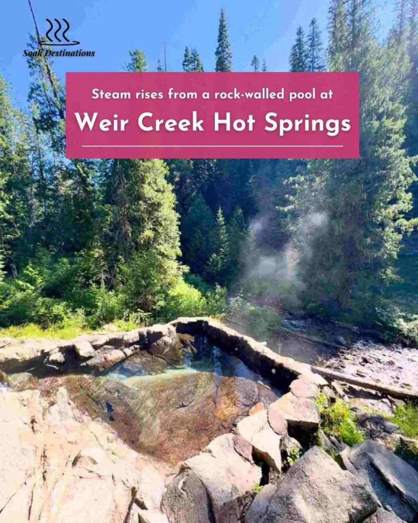 Weir Creek Hot Springs 5 - soakdestinations Steam rises from a rock-walled pool at Weir Creek Hot Springs nestled within a lush forest.