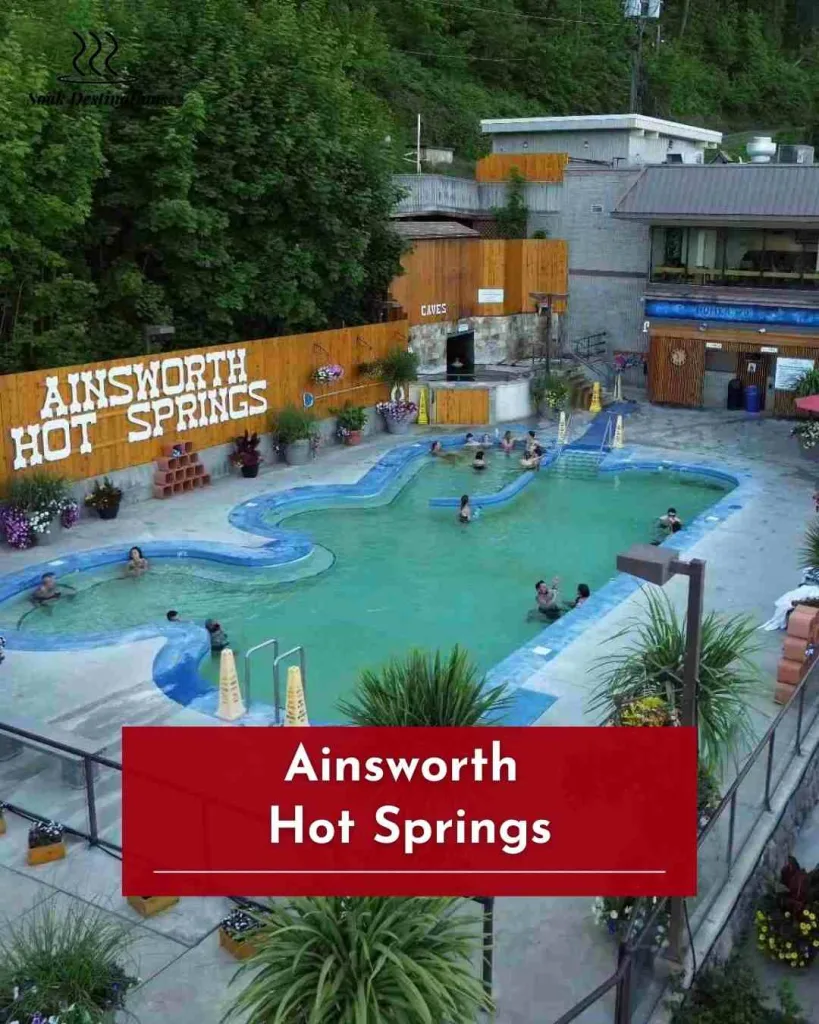 Ainsworth Hot Springs 12 - soakdestinations Guests soaking at Ainsworth Hot Springs, surrounded by lush greenery and relaxing mineral pool ambiance.