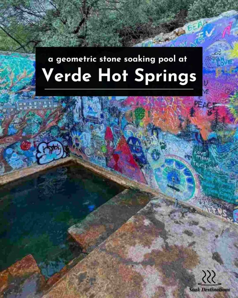 Vibrant colorful murals surround a geometric stone soaking pool at the historic Verde Hot Springs.