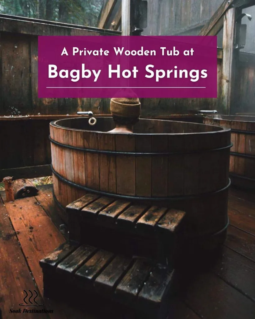 A person wearing a beanie soaks in a private wooden tub at Bagby Hot Springs. 