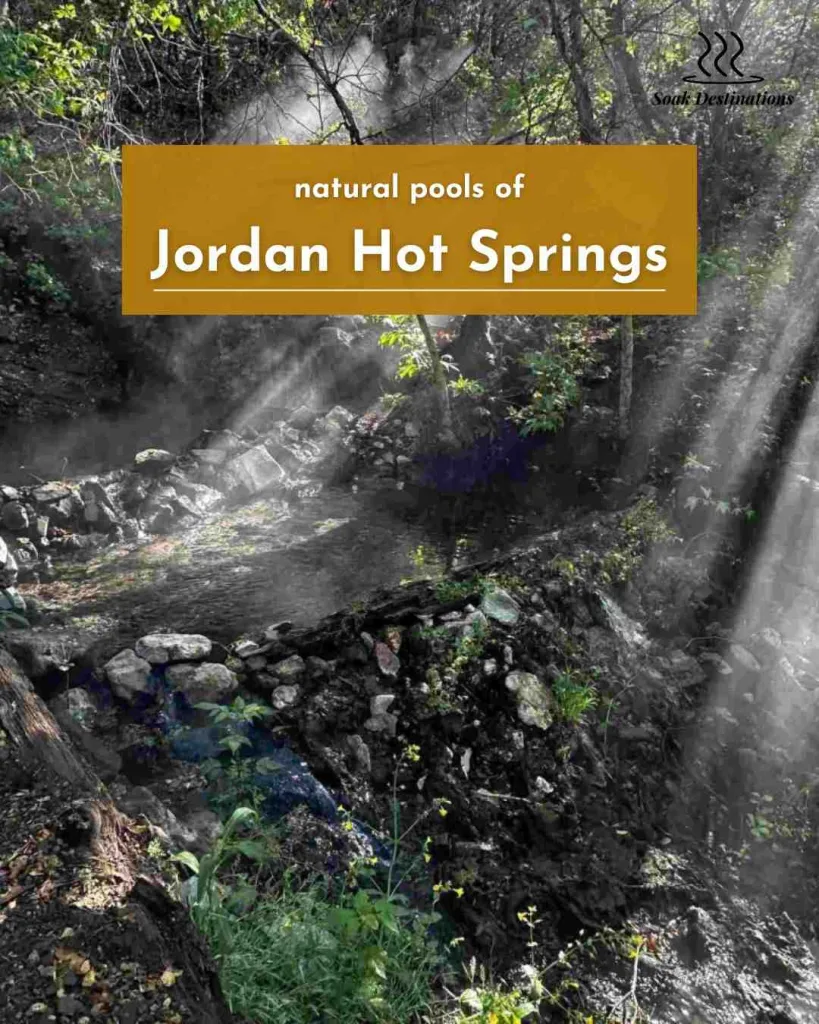 Sunlight streaks through the steam rising from the rocky, natural pools of Jordan Hot Springs.