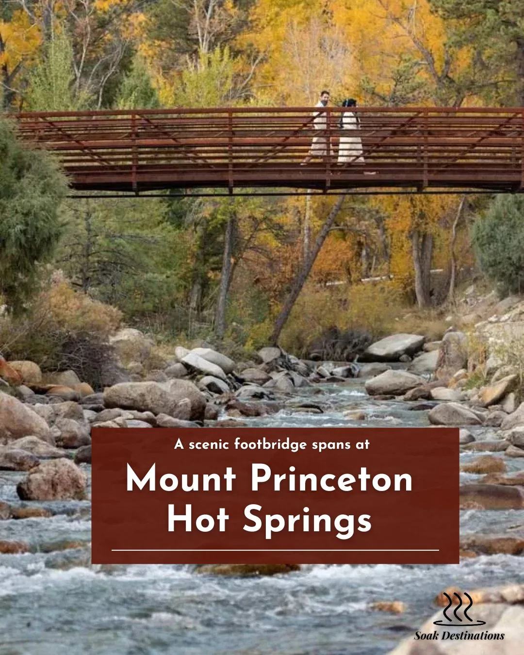 A scenic footbridge spans a rocky creek flowing through the golden autumn woods at Mount Princeton Hot Springs. 