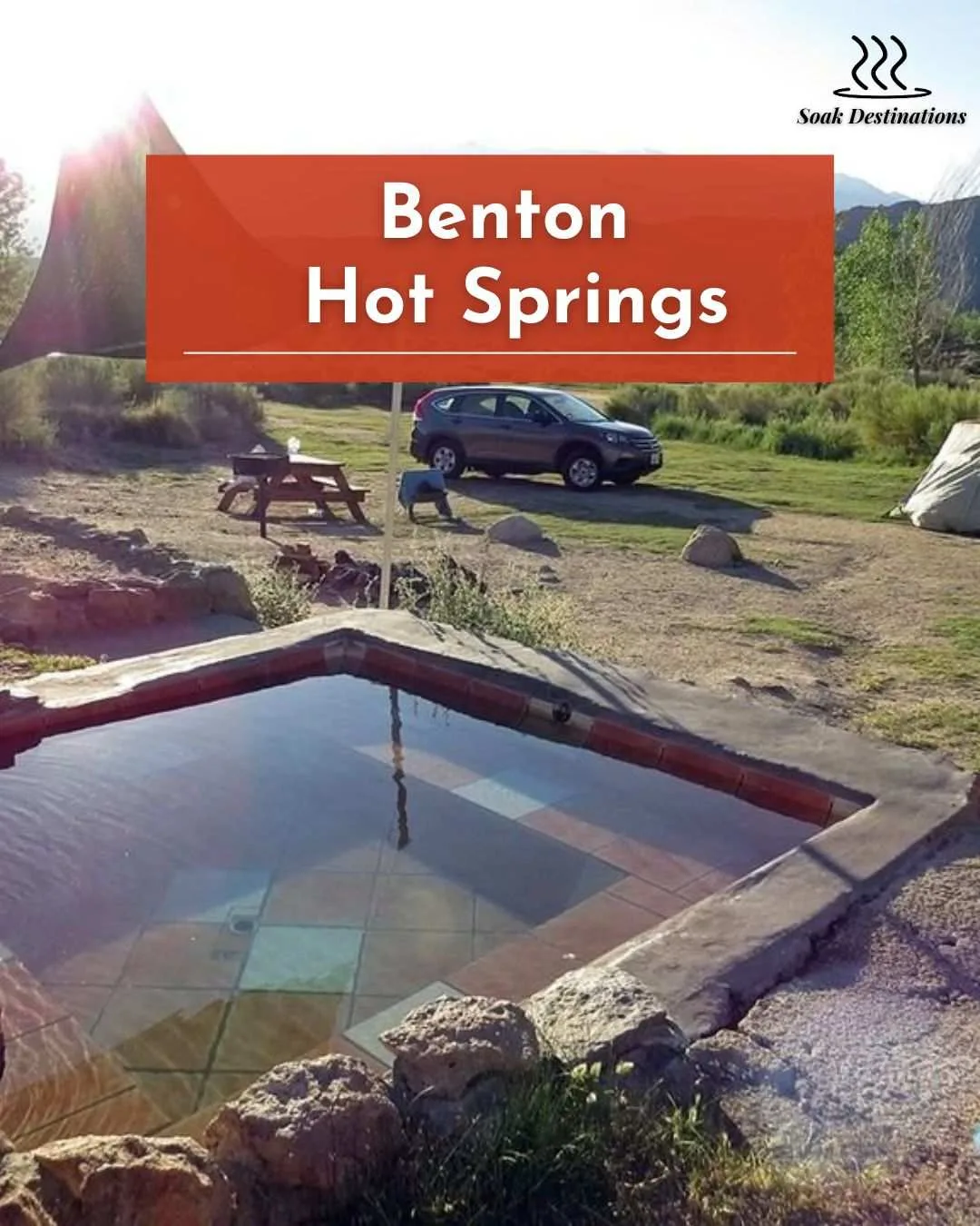 A person soaks in a private tub at Benton Hot Springs with a parked camper van. 